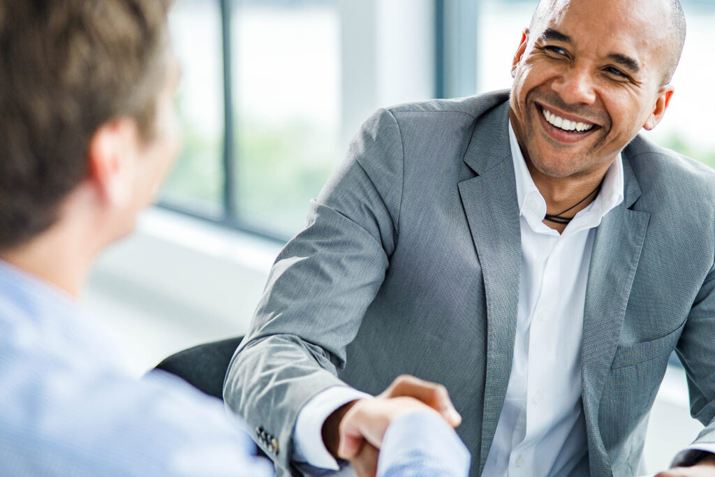 Happy black businessman came to an agreement with his colleague on a meeting.