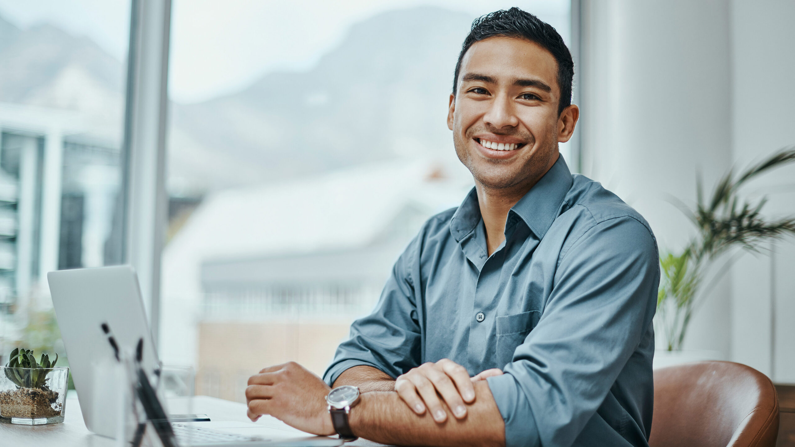 Shot of a young businessman using a laptop in a modern office